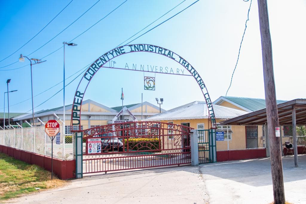 The arched entrance sign and gate of the Upper Corentyne Industrial Training Centre