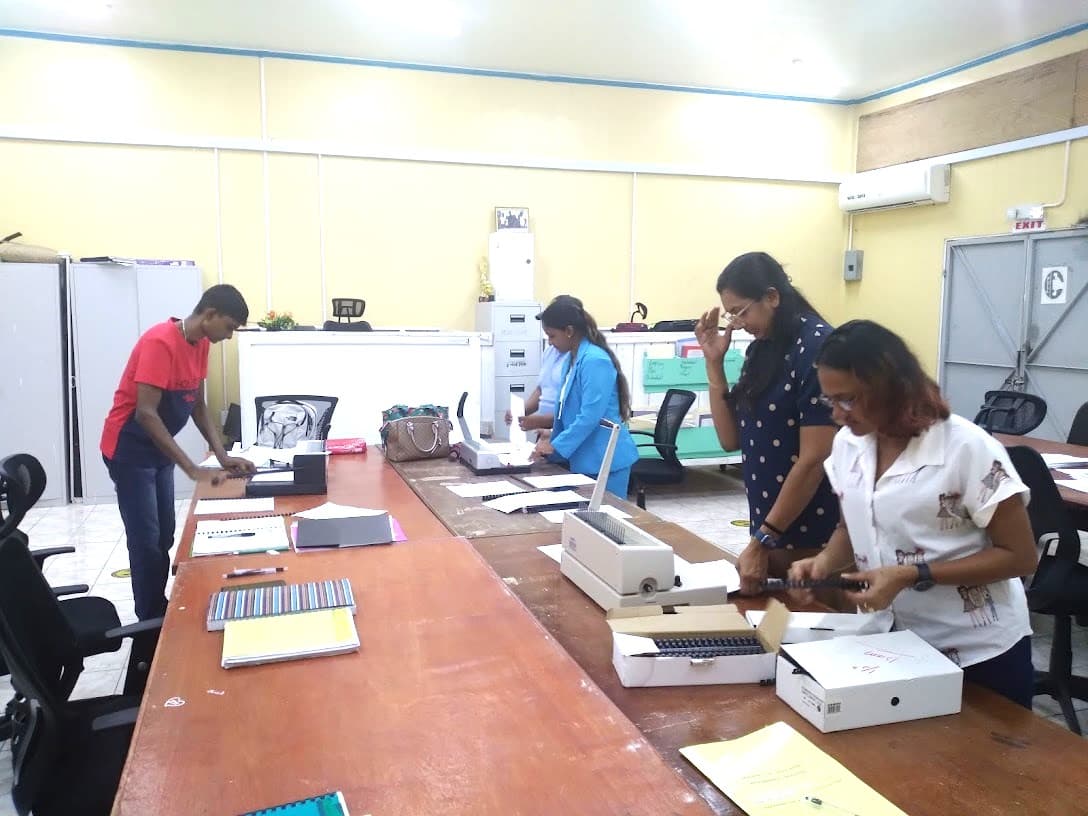 People working around a long table during a practical class activity