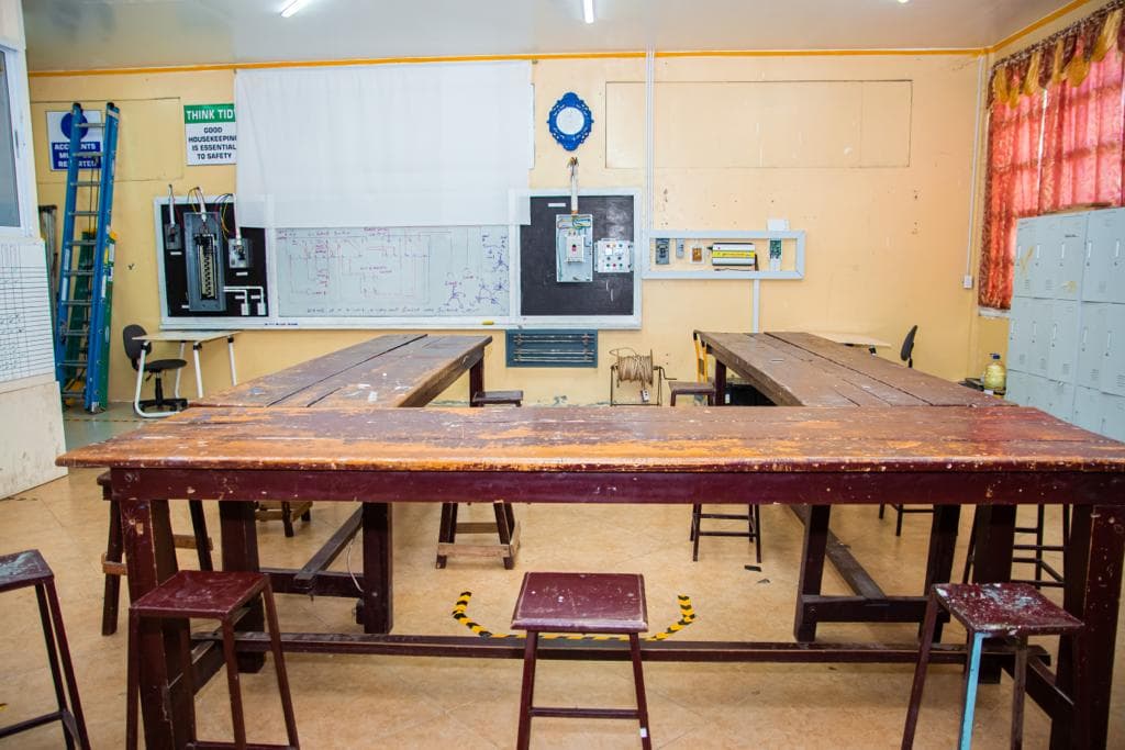 Training room with large wooden workbenches